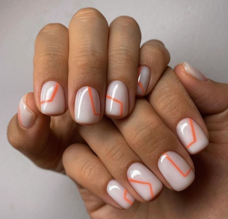 Chic Nude Nail Design with Delicate Orange Geometric Accents for Modern Elegance.