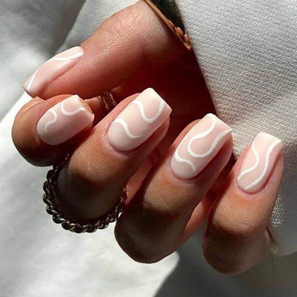 Chic Minimalist Manicure: Soft Pink Base with Wavy White Designs