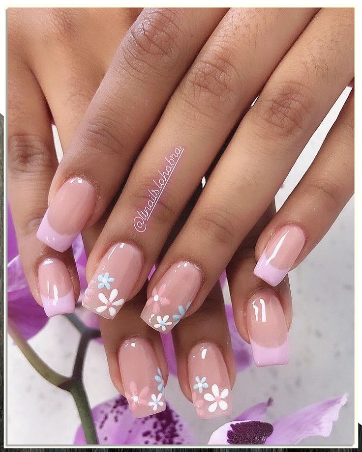 Chic Floral Nail Design with Elegant Pink French Tips on a Soft Nude Base.