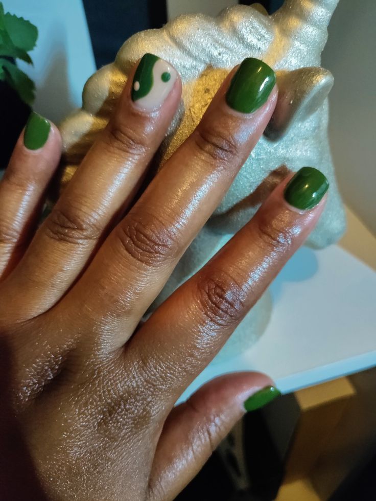 Chic Emerald Green Nail Design with Abstract Accents for a Playful Touch.