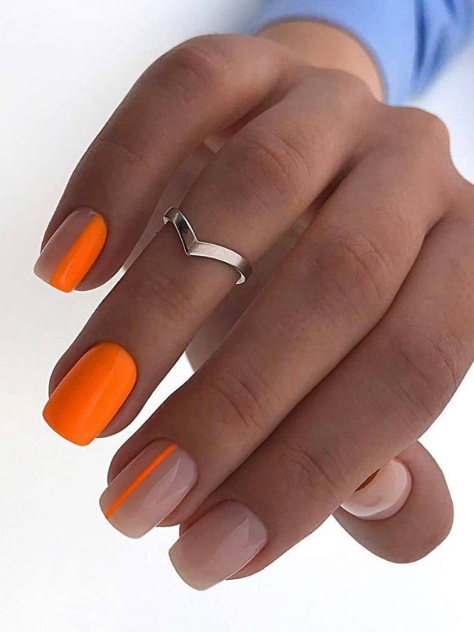 Bold Orange and Subtle Nude Nail Art with Elegant Accents.