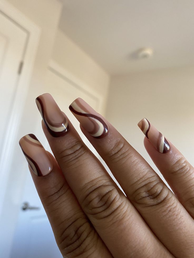 Elegant Swirl: A Modern Twist on Classic Nude and Brown Nail Design.