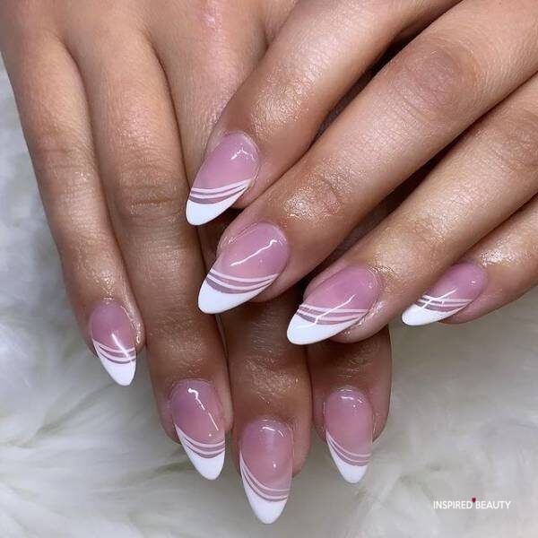 Chic Almond-Shaped Nails: Soft Pink Base with Stylish White French Tips and Modern Swirls.