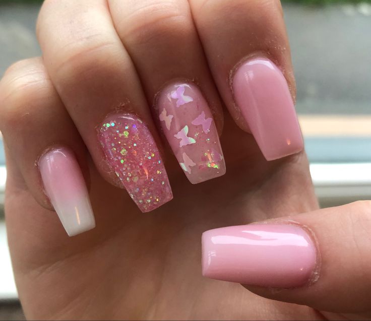 Playful and Elegant Sparkling Pink Nail Design with Ombre and Glitter Butterflies.