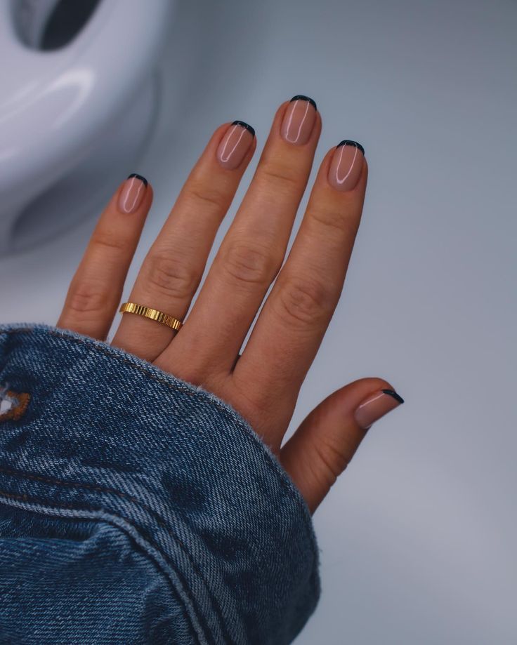 Elegant French Tip Nail Design with Modern Black Tips and Subtle Glamour.