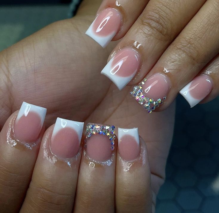 Chic French Tip Nails: Soft Pink Base, Pristine White Tips, and Dazzling Rhinestone Accent.