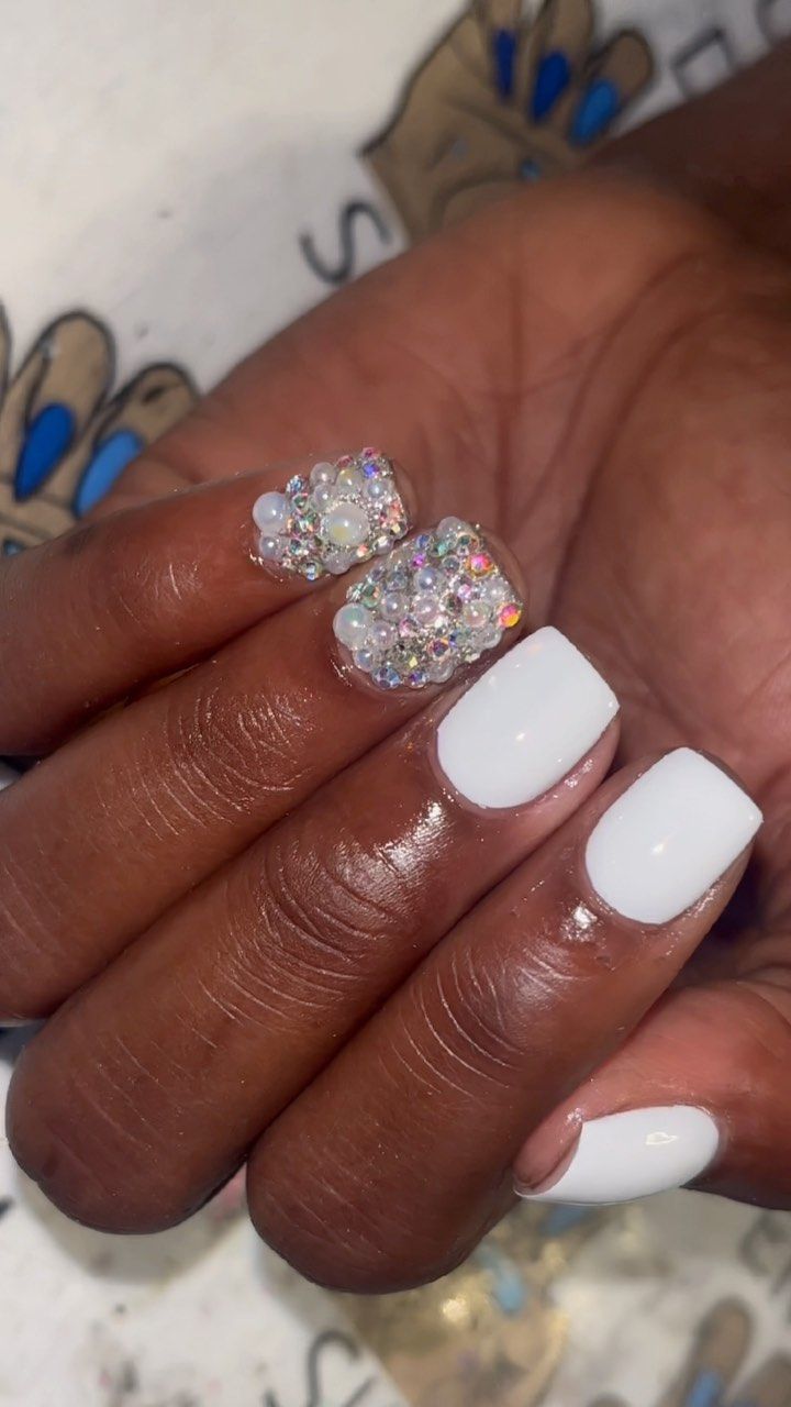 Chic Elegant Nail Design with White Base and Glamorous Rhinestone Accents.