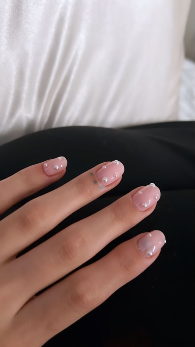 Chic and Understated Elegant Pink Nail Design with Pearl Accents.