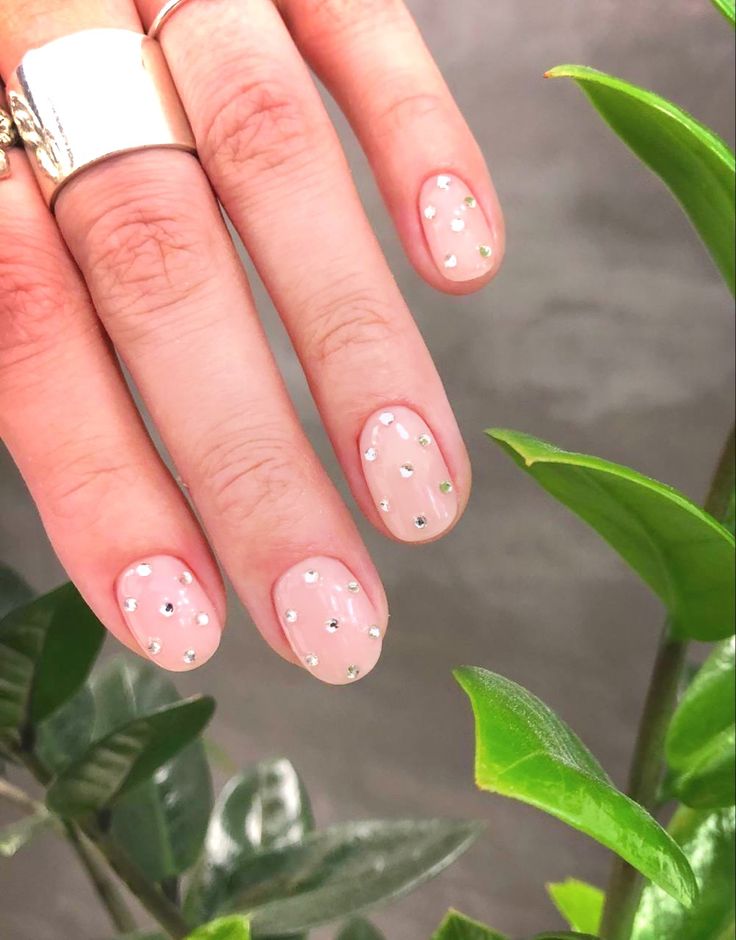 Elegant Soft Pink Nail Design with Sparkling Silver Rhinestones.