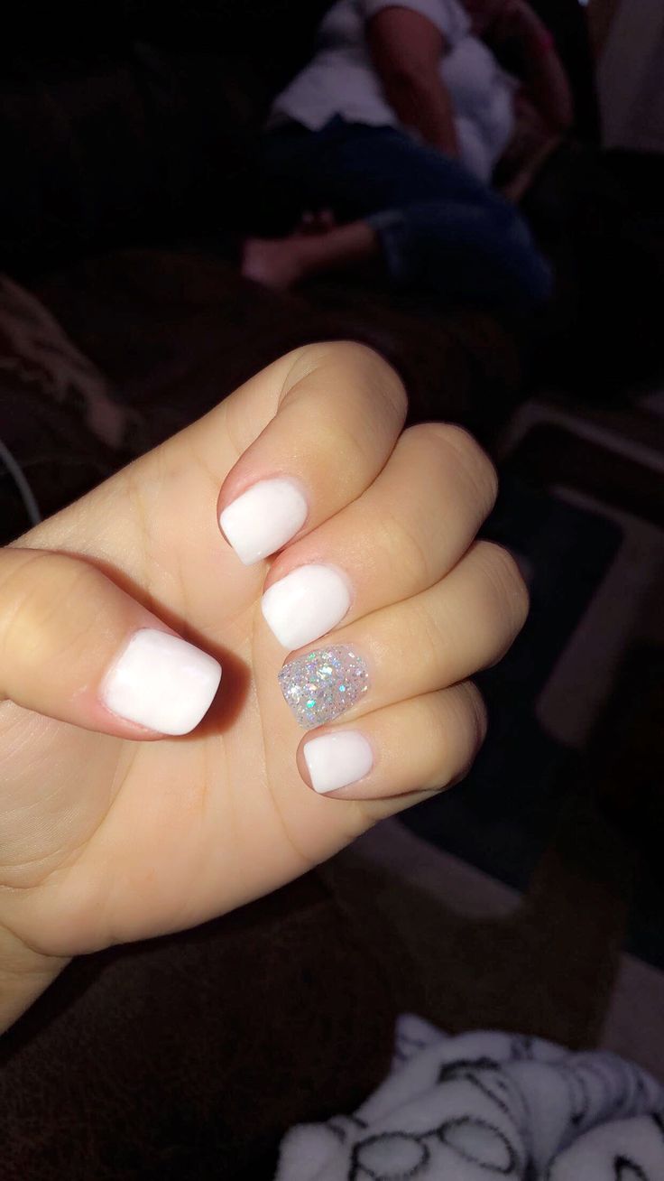 Chic White Nail Design with Glitter Accent for a Sophisticated Look.