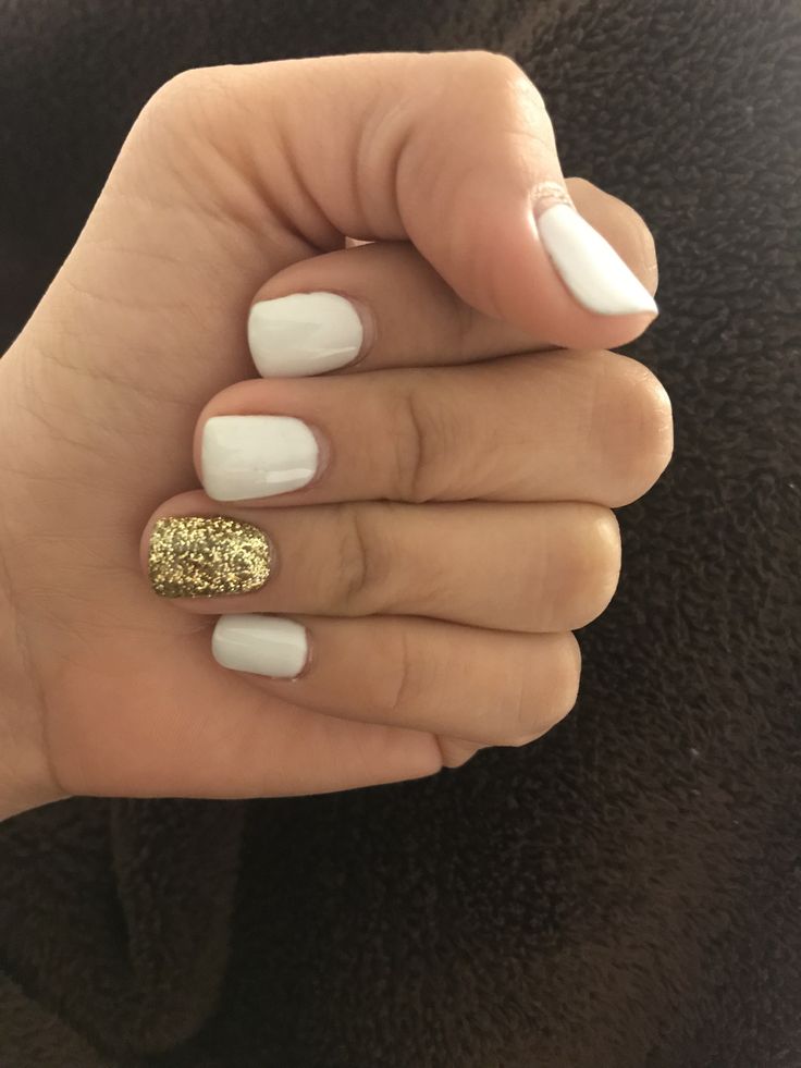 Elegant Chic Nail Design: Classic White Base with Glamorous Gold Glitter Accent.