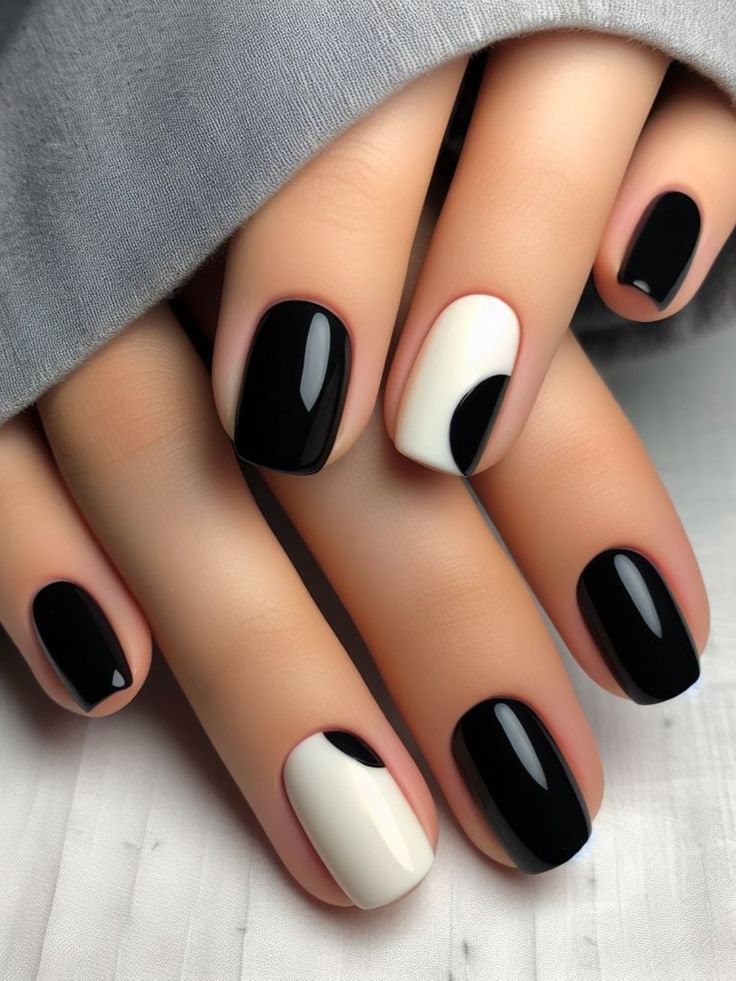 Chic Monochromatic Nail Design: Bold Black with Eye-Catching White Accent.