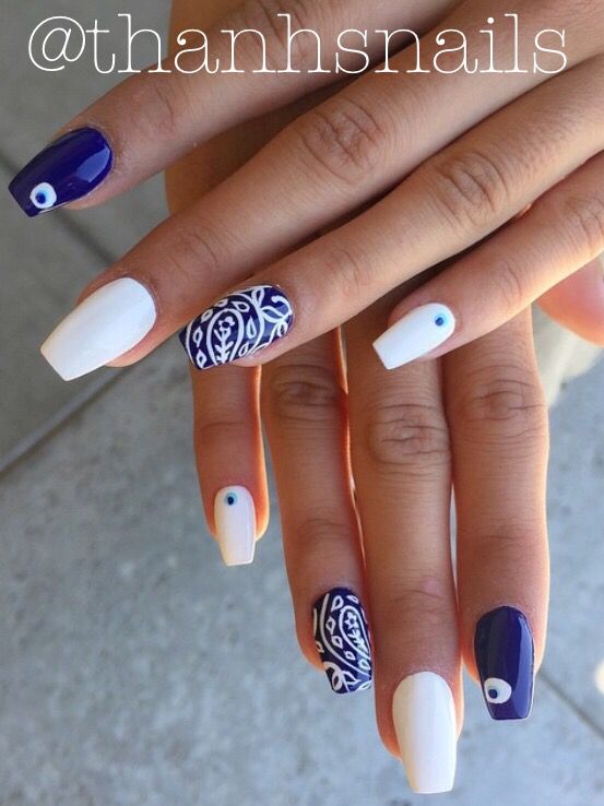 Elegant Navy and White Nail Design with Intricate Patterns and Eye Motifs