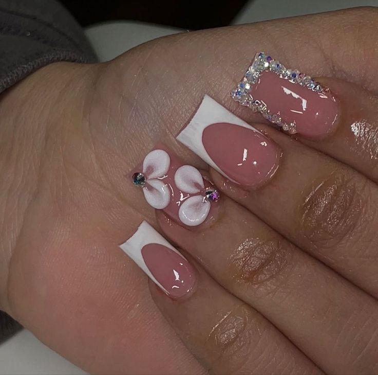 Elegant Floral Nail Design with Soft Pink Base and Glamorous Iridescent Accents.