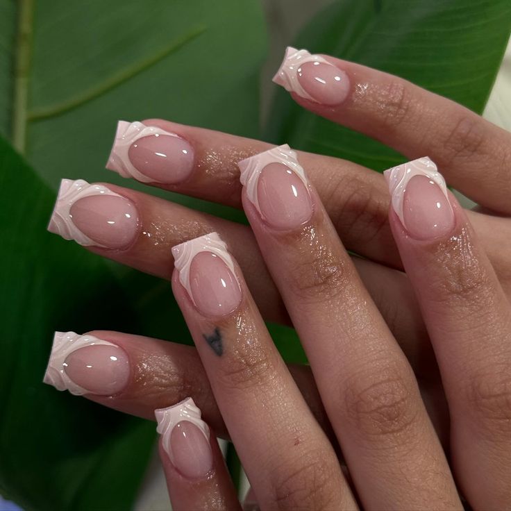 Sophisticated Soft Pink Nail Design with Intricate White Tips for All Occasions.