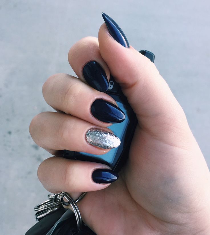 Sophisticated Navy Almond Nails with Glamorous Silver Glitter Accent.