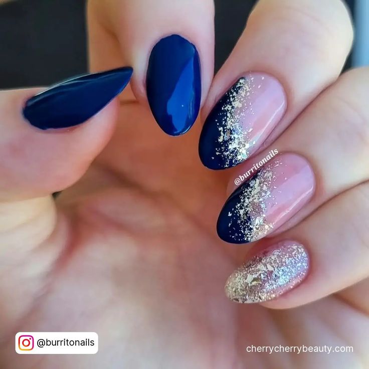 Elegant Navy Blue and Soft Pink Nail Design with Glamorous Gold Accents.