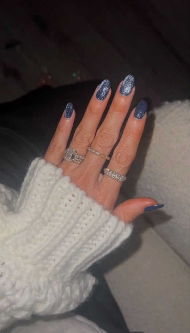 Chic Deep Navy Nail Design with Glitter Accents for Elegant Occasions.