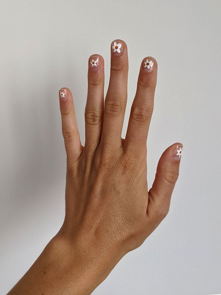 Chic Soft Nude Nails with Delicate White Floral Tips