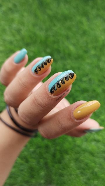 Playful Turquoise and Mustard Yellow Nail Design with Curved Black Line Accents.