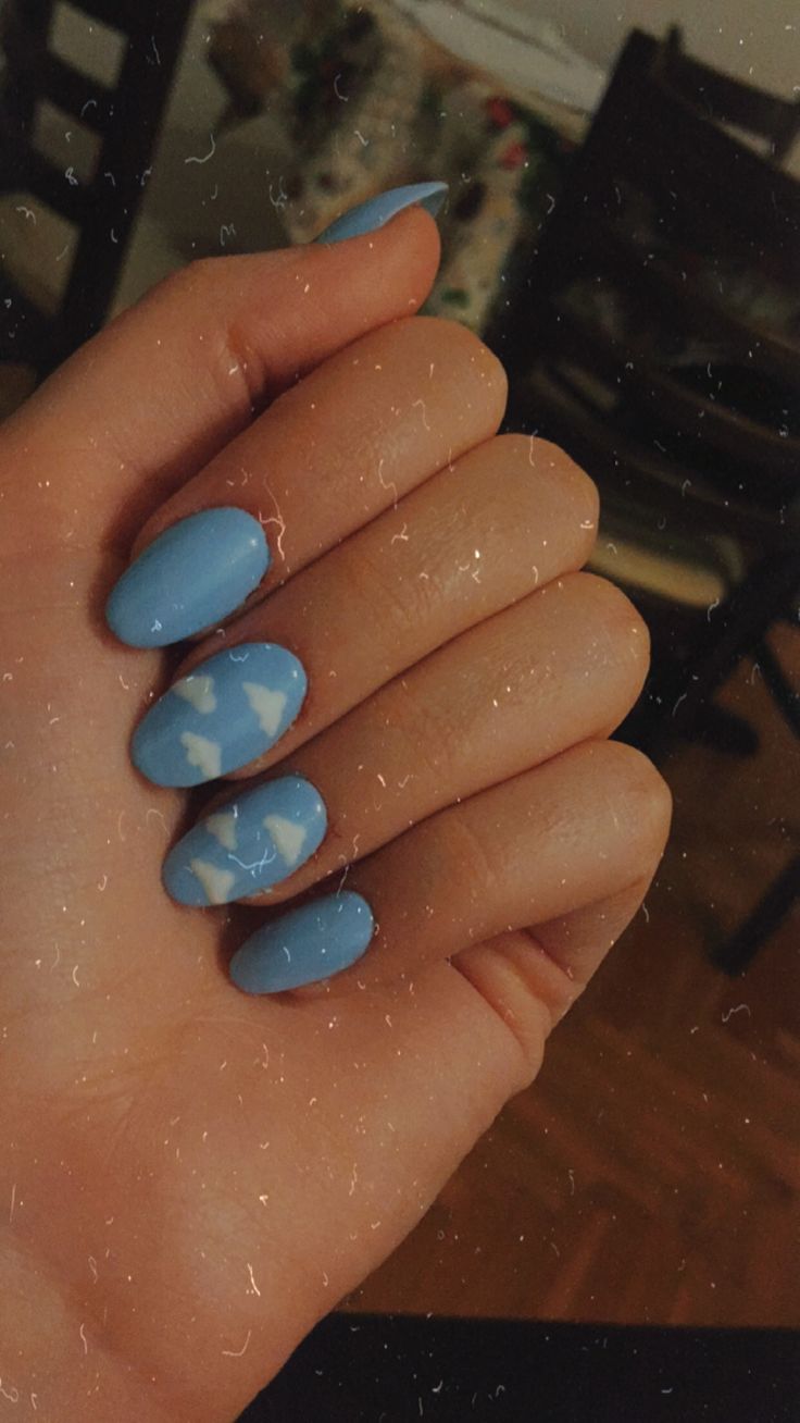 Sky-Inspired Nail Design: Soft Blue Base with Artistic Cloud Accents and Dimensional Finishes