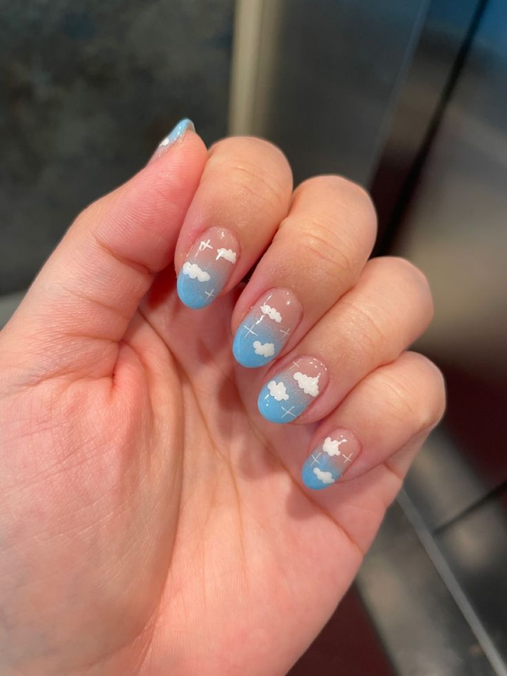 Whimsical Cloudy Sky Nail Design with Light Blue Gradients and Delicate White Clouds