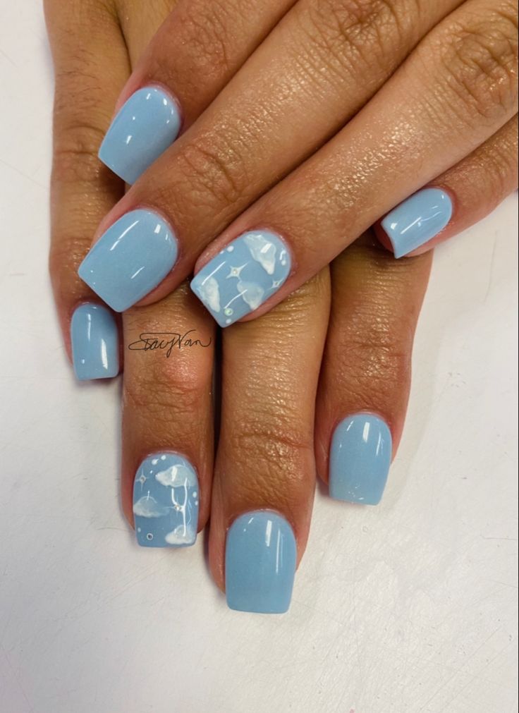 Chic Soft Blue Nail Design with Glossy Finish and Playful Cloud Patterns