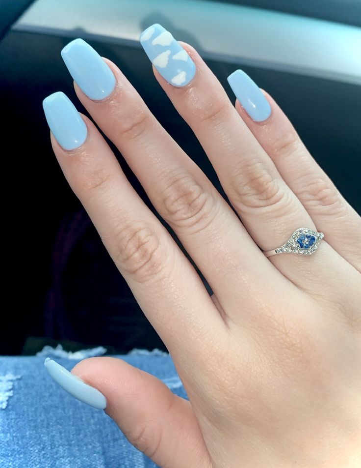 Elegant Glossy Blue Nails with Whimsical Cloud Accent Design.