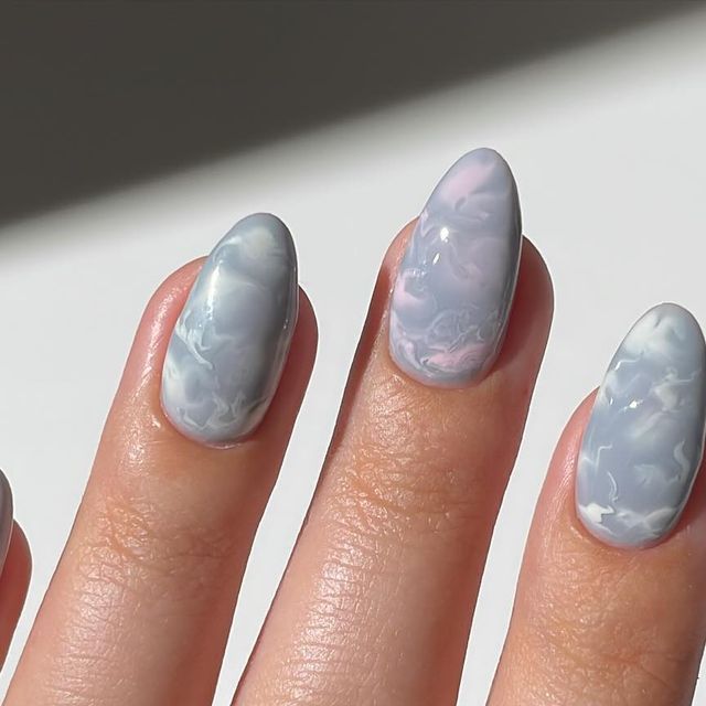 Chic Marbled Nail Design in Soft Gray and Pastel Tones for Elegant Almond-Shaped Nails.