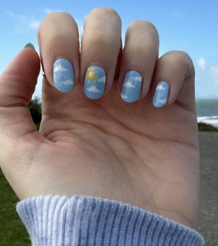 Whimsical Sky-Themed Nail Art: Serene Blue with Clouds and Radiant Sun