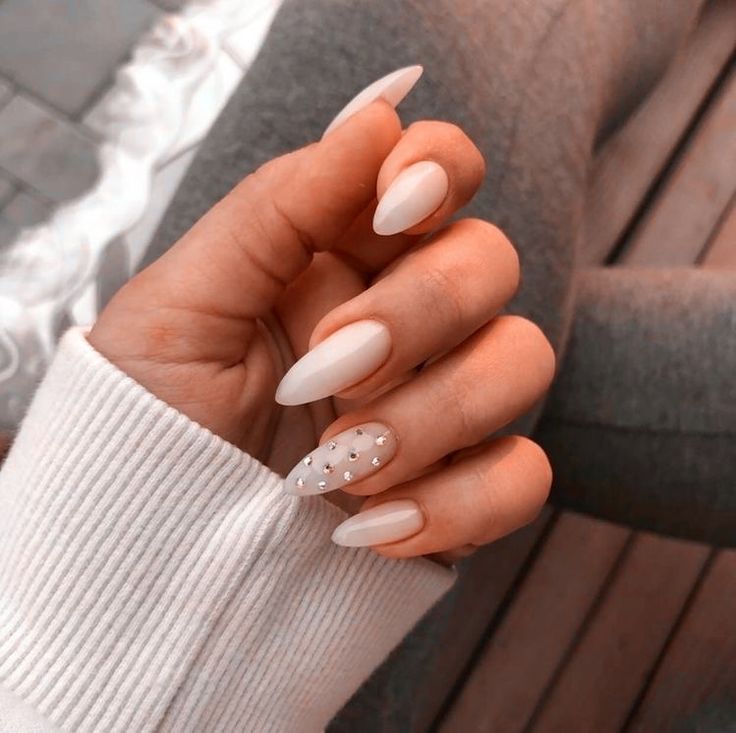 Chic Almond-Shaped Nails with Glossy White Finish and Sparkly Accent