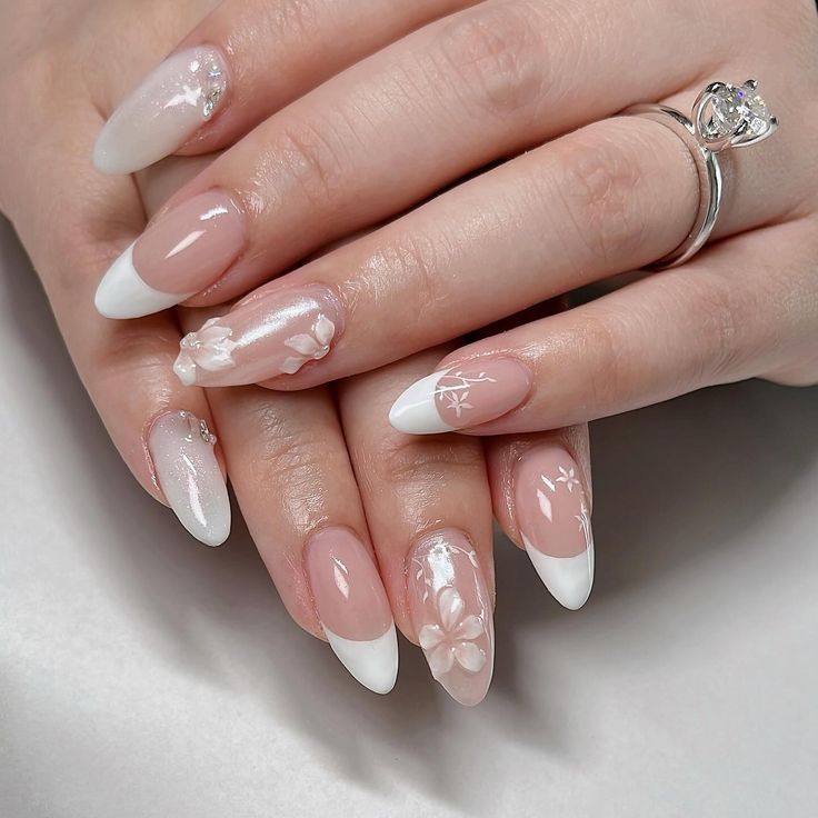 Sophisticated Nail Design: Soft Nude and White with Floral Patterns and Shimmering Accents.