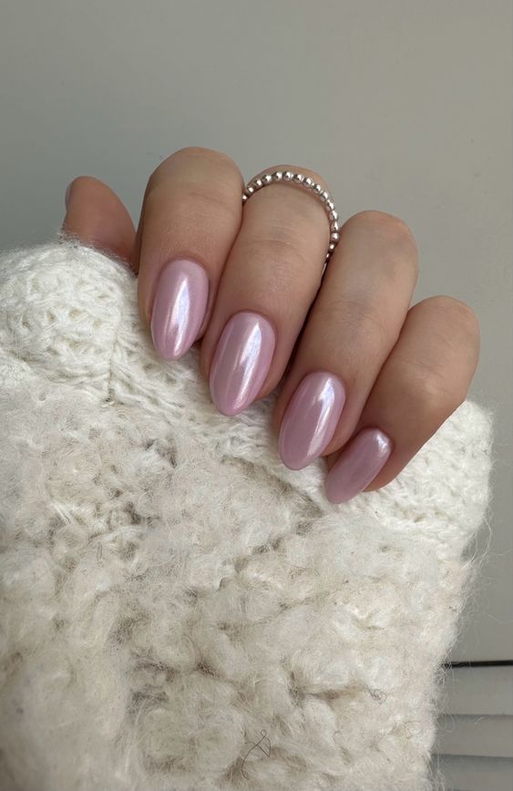 Chic Almond-Shaped Nails with Iridescent Pink Finish and Elegant Accents.