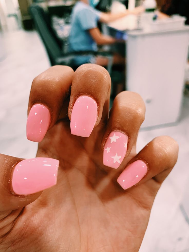 Playful Pink Nails with Glossy Finish and Whimsical Star Accent.