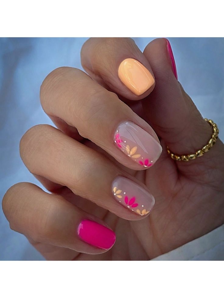 Playful Floral Nail Design with Pastel Hues and Bold Pink Accents.