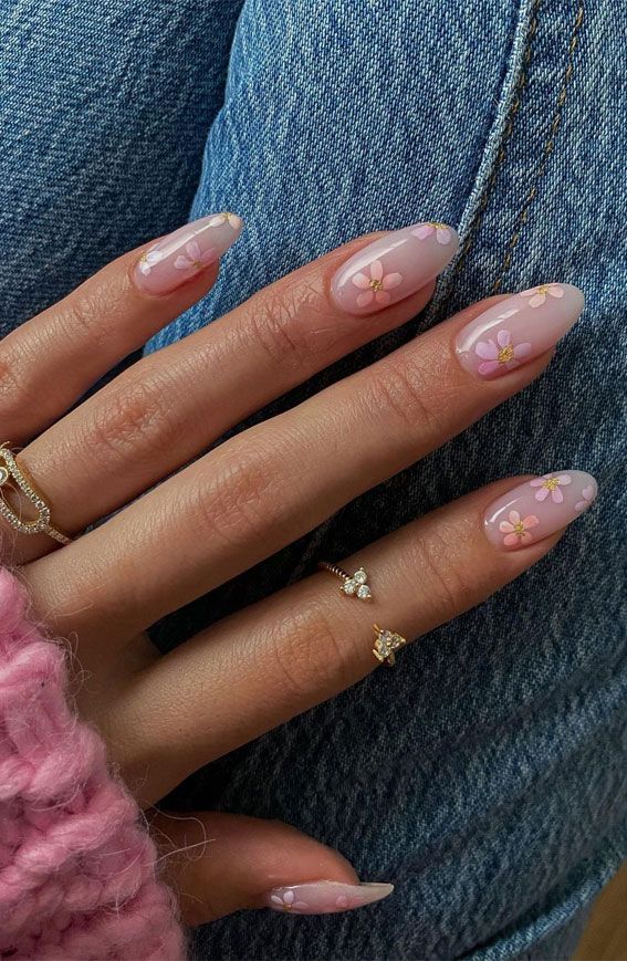 Charming Whimsical Floral Nail Design with Soft Pink Hues and Gold Accents.