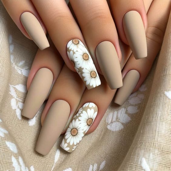 Sophisticated Matte Beige Nail Design with Delicate White Daisy Accent.