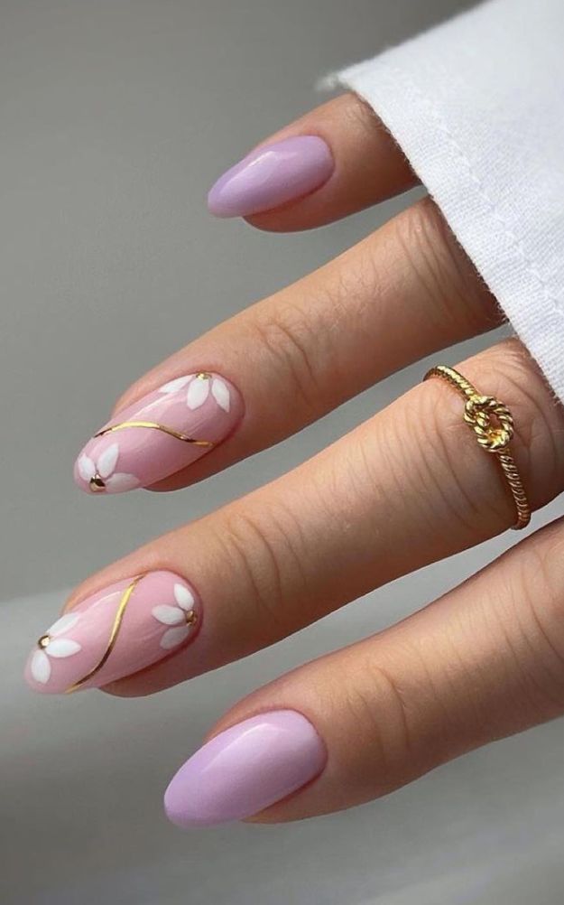 Sophisticated Delicate Pink Nail Design with Floral Accents and Glossy Finish.