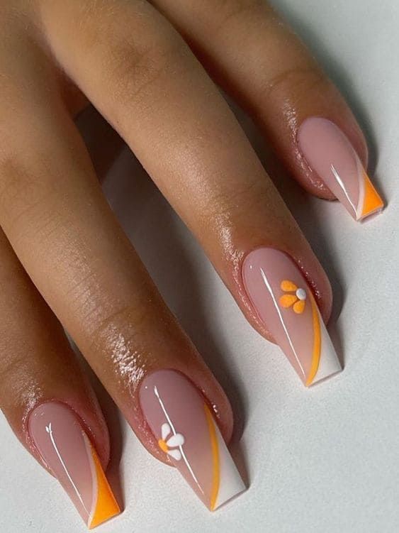 Elegant Nail Design: Soft Pink and White with Floral Accents and Sleek Orange Lines