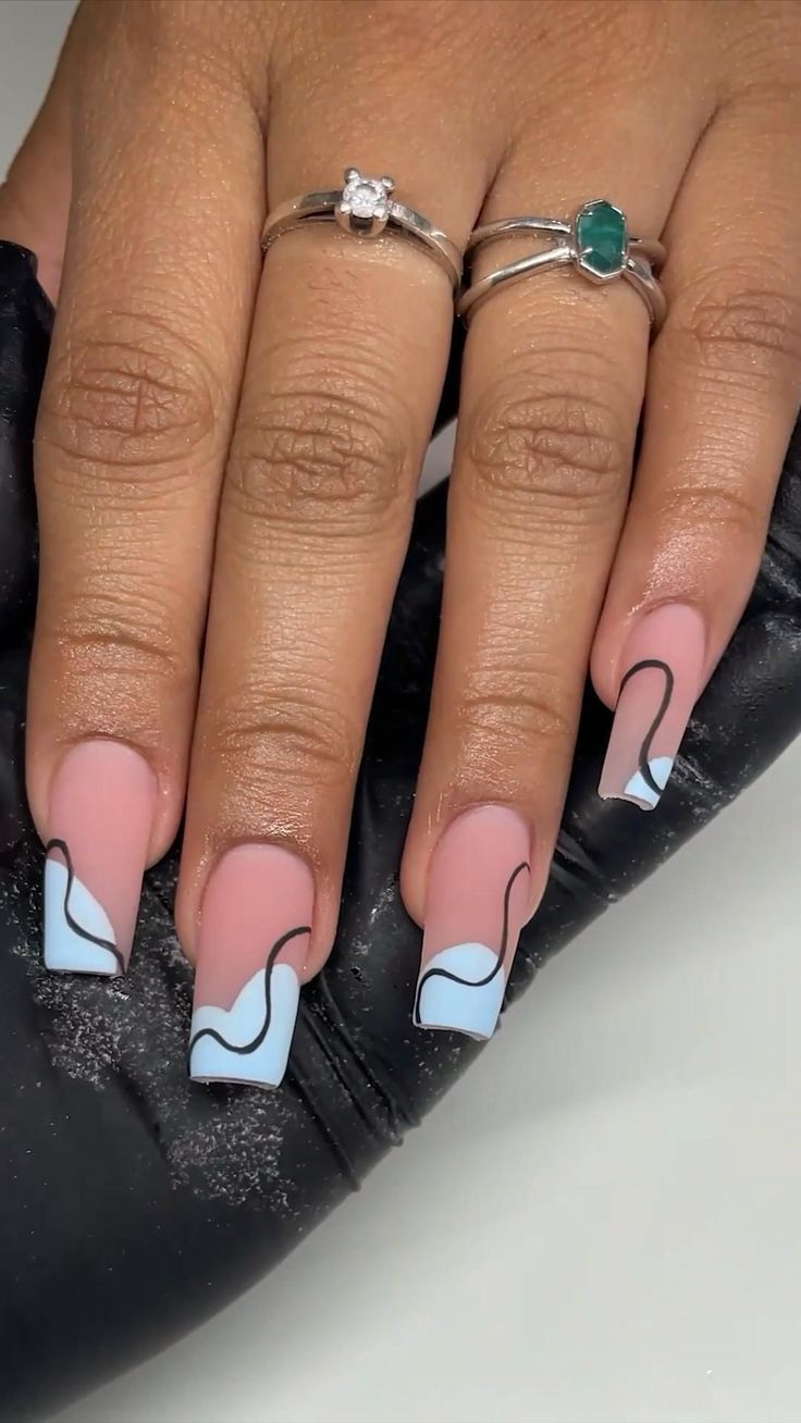 Captivating Pastel Nail Design: Elegant Pink and Sky Blue with Chic Silver Accents.