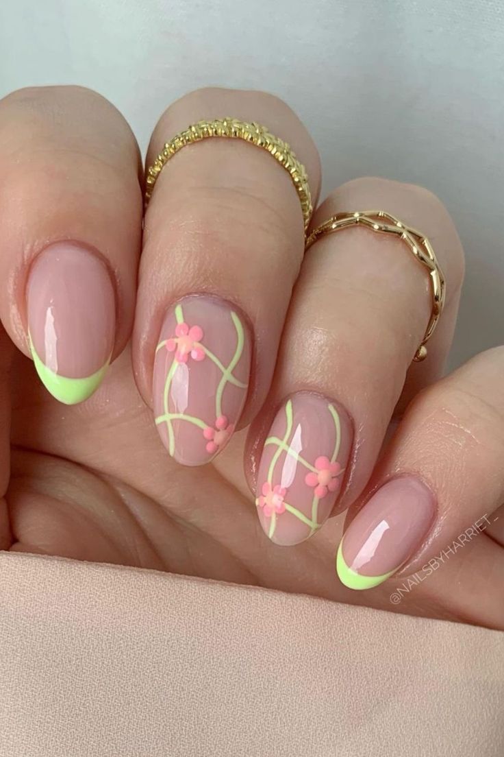 Playful Soft Pink Nail Design with Neon Green Tips and Floral Patterns for Spring/Summer Elegance.