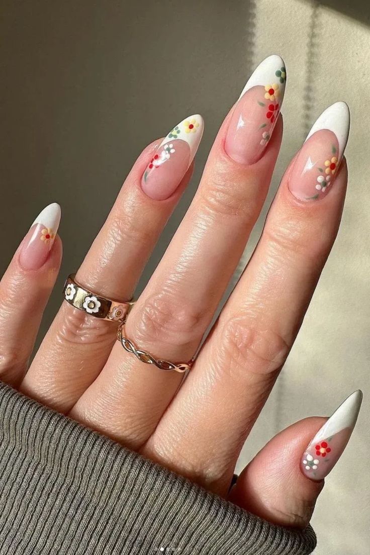 Elegant Almond-Shaped French Tip Nails with Vibrant Floral Designs.