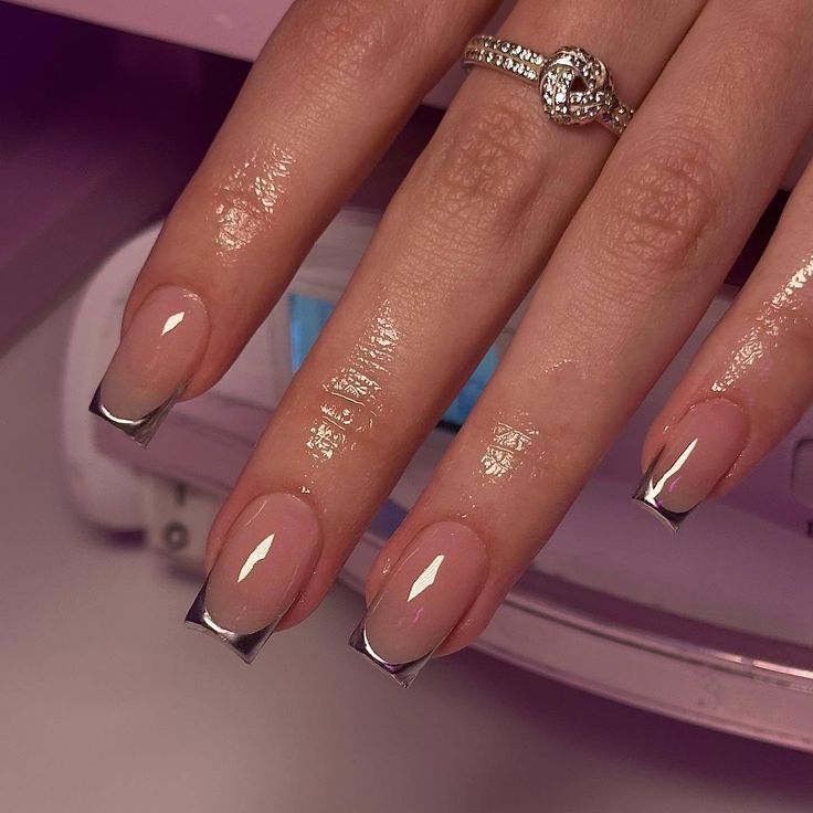 Sophisticated Ombre Nails Featuring Metallic Silver Tips and Glossy Finish