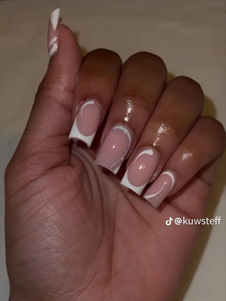 Chic Soft Pink and White Nail Design with Artistic Flair.