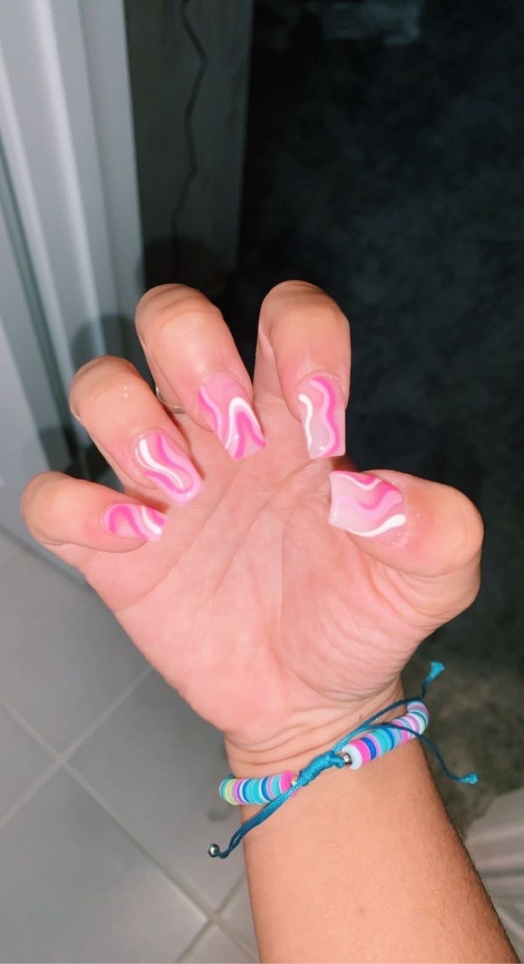 Vibrant Pink and White Swirled Nail Design for a Trendy and Modern Look.