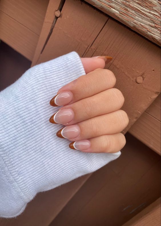 Chic Modern French Tip Nail Design with Striking Brown Tips on a Soft Nude Base.