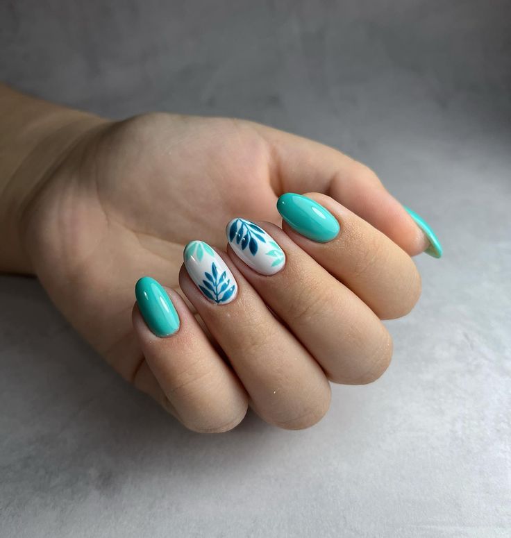 Vibrant Turquoise Nail Design with Intricate Blue Leaf Accents