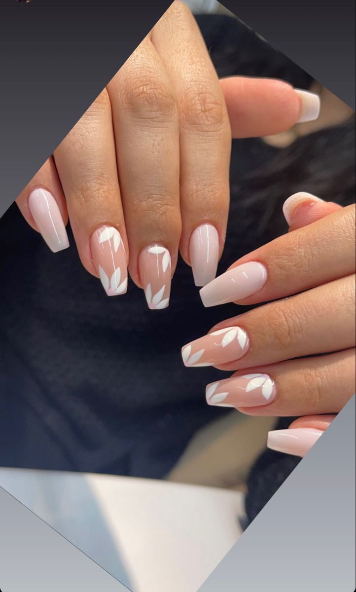 Elegant Soft Pink Nail Design with Delicate White Leaf Accents.