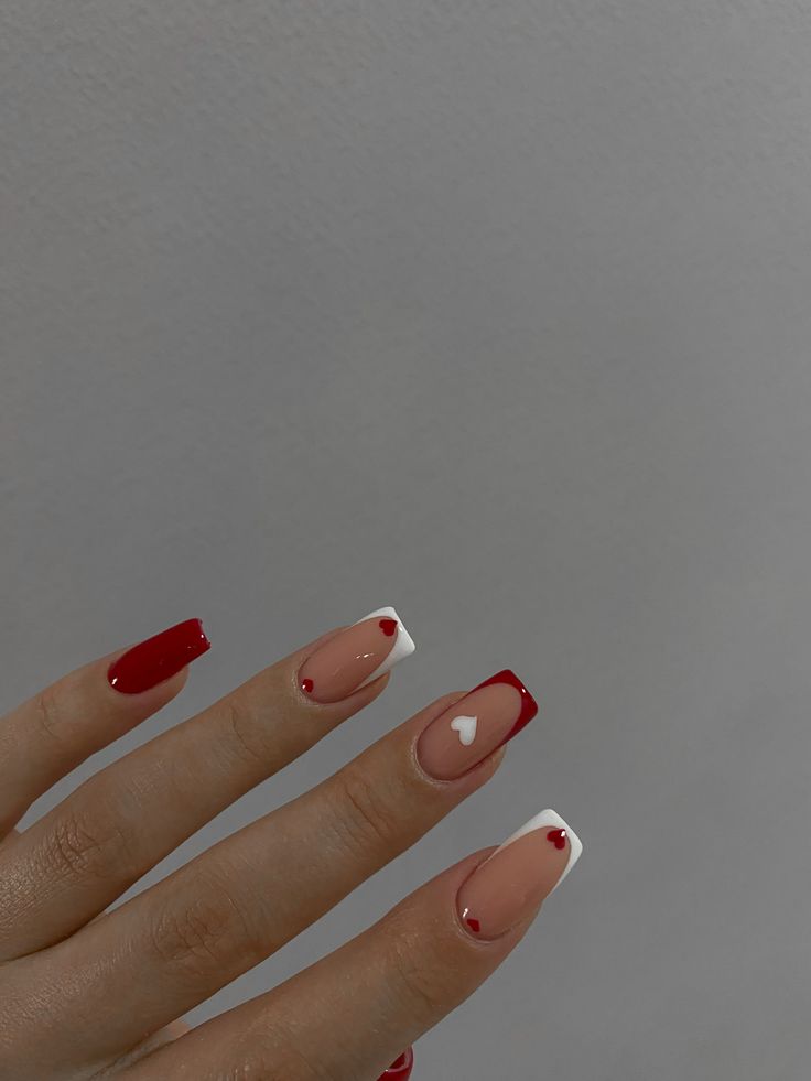 Romantic Nail Design with Red, Nude, and White Shades Adorned with Elegant Hearts