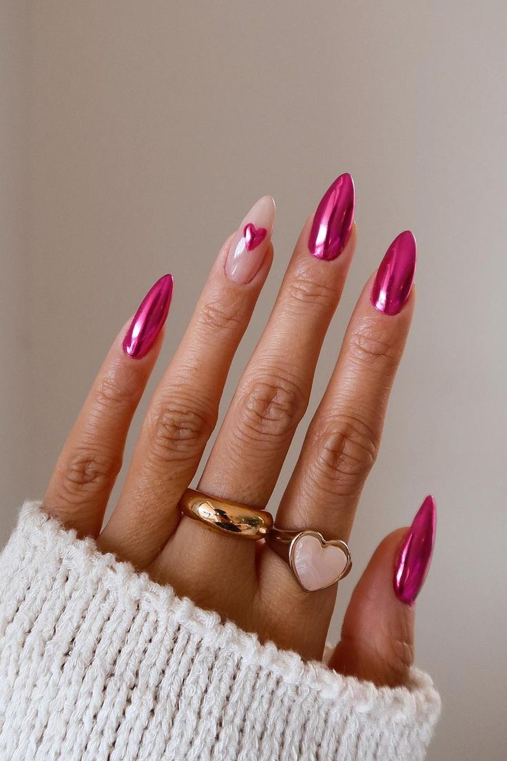 Chic Almond-Shaped Nails with Glossy Pink and Nude Design, Adorned with Heart Accents and Elegant Jewelry.